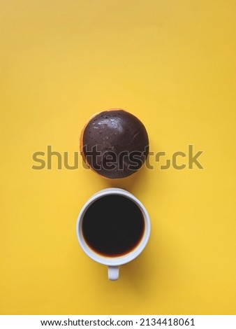 Morning with cup of hot coffee and sweet donuts on yellow background. Top view, copy space, mockup. Flat lay. Food and drinks. Spring holidays. 