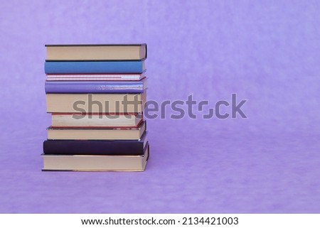School books on purple background