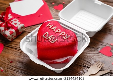 Plastic lunch box with tasty bento cake on wooden background, closeup