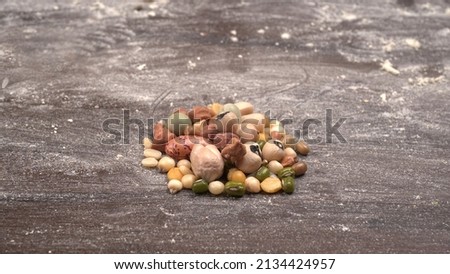 Mixed dry organic cereal and grain seed pile on wooden background. For healthy food ingredient or carbohydrate food type and agricultural product concept. Royalty-Free Stock Photo #2134424957