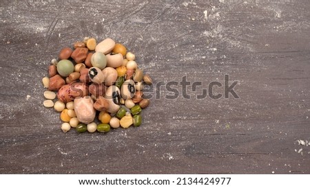 Mixed dry organic cereal and grain seed pile on wooden background. For healthy food ingredient or carbohydrate food type and agricultural product concept. Royalty-Free Stock Photo #2134424977