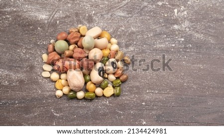 Mixed dry organic cereal and grain seed pile on wooden background. For healthy food ingredient or carbohydrate food type and agricultural product concept. Royalty-Free Stock Photo #2134424981