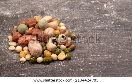 Mixed dry organic cereal and grain seed pile on wooden background. For healthy food ingredient or carbohydrate food type and agricultural product concept. Royalty-Free Stock Photo #2134424985