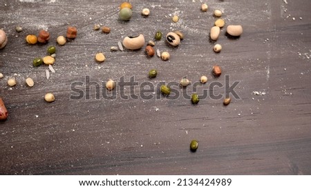 Mixed dry organic cereal and grain seed pile on wooden background. For healthy food ingredient or carbohydrate food type and agricultural product concept. Royalty-Free Stock Photo #2134424989