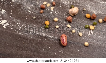 Mixed dry organic cereal and grain seed pile on wooden background. For healthy food ingredient or carbohydrate food type and agricultural product concept. Royalty-Free Stock Photo #2134424991