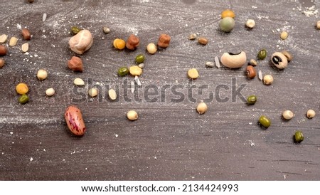 Mixed dry organic cereal and grain seed pile on wooden background. For healthy food ingredient or carbohydrate food type and agricultural product concept. Royalty-Free Stock Photo #2134424993