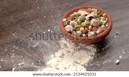Mixed dry organic cereal and grain seed pile on wooden background. For healthy food ingredient or carbohydrate food type and agricultural product concept. Royalty-Free Stock Photo #2134425031