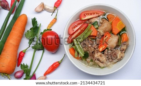 Chicken soup with vegetables and basic ingredients for background and isolated on white 