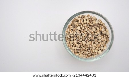 Job's Tears in the bowl, also known as adlay and coix on white background. Popular in Asian cultures as a food source.