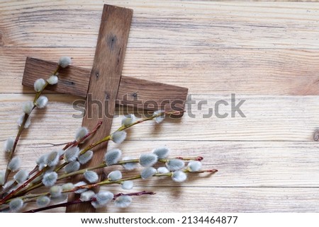 Easter cross with catkins on wooden background, palm sunday religious concept abstract Royalty-Free Stock Photo #2134464877