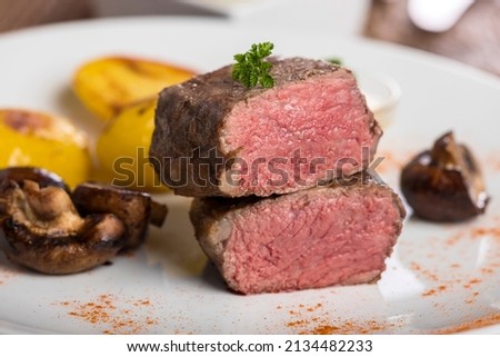 slices of a grilled steak on a plate Royalty-Free Stock Photo #2134482233