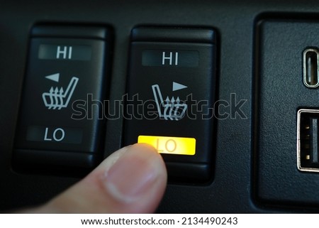 A switch to activate heated seats in car seats. Royalty-Free Stock Photo #2134490243