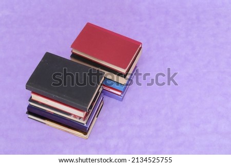 School books on purple background