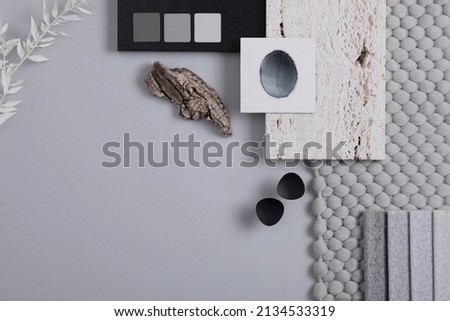 Stylish architect and interior designer moodboard. Flat lay composition in grey color palette with textile and paint samples, panels and tiles. Top view. Copy space. Template.
