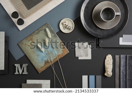Creative flat lay composition with textile and paint samples, panels and tiles. Stylish interior designer moodboard. Black, blue, beige and dark grey color palette. Copy space. Template. 
