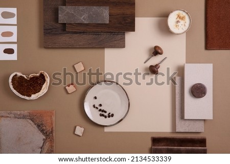 Flat lay of creative architect moodboard composition with samples of textile, paint, panels and tiles. Natural materials. Beige and brown color palette. Top view. Copy space. Template.