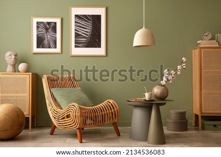 Stylish living room interior design with armchair, modern commode, mock up frames and creative home accessories. Template. Copy space.
