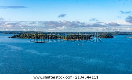 Beautiful early morning scenery with an open view of the natural environment and natural archipelago with plenty of islands standing on the water surface.   Royalty-Free Stock Photo #2134544111