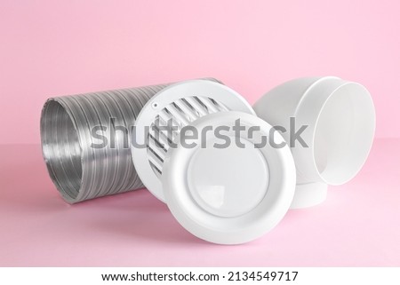 Parts of home ventilation system on pink background