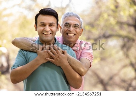 Happy senior man embracing adult son and admiring view at park
 Royalty-Free Stock Photo #2134567251
