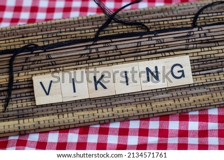 a collection of letters from wooden blocks with Viking inscriptions on a Japanese mat