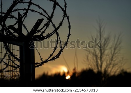 Barbed wire fence and Light of Hope. Royalty-Free Stock Photo #2134573013