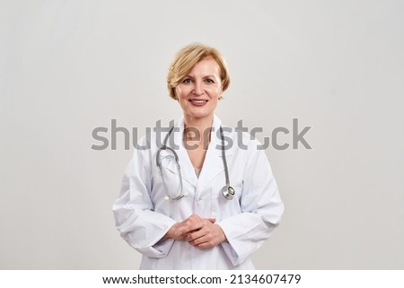 Cropped image of smiling female doctor looking at camera. woman with stethoscope wearing white coat. Concept of medical and health care. Isolated on white background. Studio shoot. Copy space Royalty-Free Stock Photo #2134607479