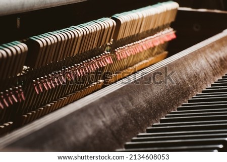 Inside of a piano - keyboard and strings for piano player - wood and industrial - jazz