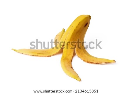 Close-up of a banana peel on the ground on a white background. Concept of organic waste Royalty-Free Stock Photo #2134613851