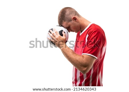 Side view of young male caucasian athlete touching soccer ball on forehead against white background. unaltered, sport, competition and game concept.