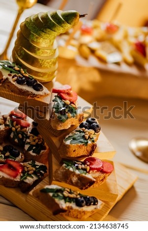 Bruschetta with different fillings on the plate. Gray concrete background. Catering Service Photography.