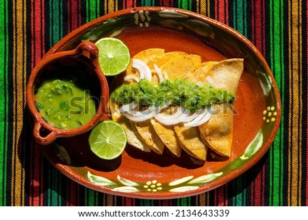  Delicious traditional basket tacos (Tacos de Canasta) from Mexico. Cooked pork rinds, potatoes, beans and potatoes. Accompanied by lemon and a spicy green sauce