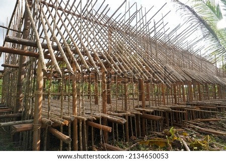 The Asmat traditional house in Papua is in the form of a long house whose construction uses wood material so that it looks environmentally friendly and natural, (Asmat Papua Indonesia, March 8, 2022) Royalty-Free Stock Photo #2134650053