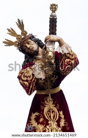 Procession of Jesus in the Holy Week of Spain, Andalusia, Granada. Holy week in seville. Painful face of crucified christ with cross on his back. phot vertical