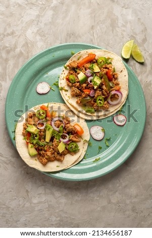 Ground beef tacos with avocado and bell peppers. Traditional mexican food