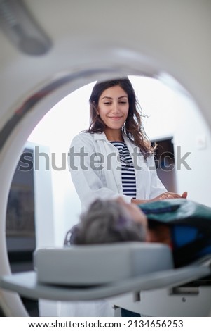 This wont hurt a bit. Shot of a mature woman being comforted by a doctor before and MRI scan. Royalty-Free Stock Photo #2134656253
