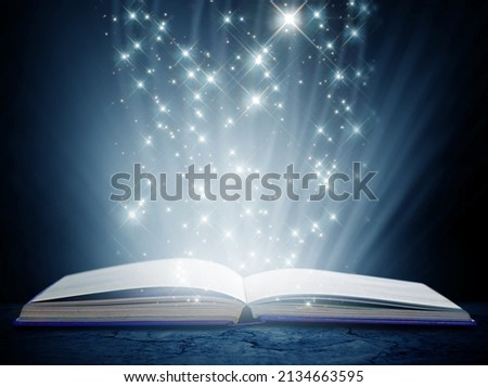 Containing a world of magic and wonder. A book on an isolated background with a bright,magical glow emanating from it. Royalty-Free Stock Photo #2134663595