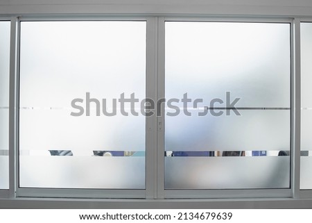 Window with frosted glass texture on the office glass for reduced visibility across, Toilet wall sticker bathroom decoration, Decorative Glass Film. Royalty-Free Stock Photo #2134679639