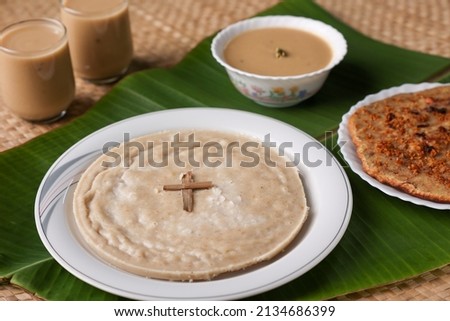 Pesaha Appam, Bread ,Paal religious Christian food on Maundy Thursday, Happy, Good Friday with rice flour Kerala India Sri Lanka. Palm Sunday, Easter Sunday. Top view cross of coconut palm leaf Royalty-Free Stock Photo #2134686399