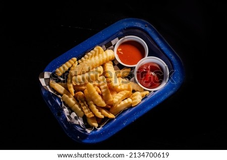 French fries. American fast food restaurant cuisine - deep and ketchup and heap of potato chips.

