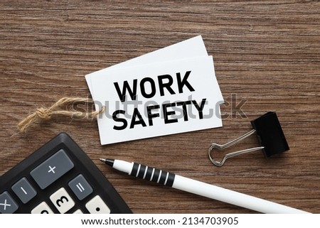 Work Safety. business card on a wooden background .text on a white business card