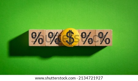 Dollar and percent symbols on wooden cubes.