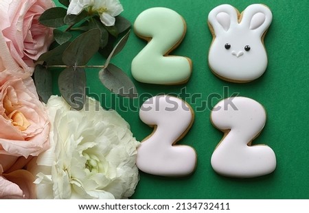 Easter 2022. Cute Easter flat lay with bunny on green background with space for your logo 