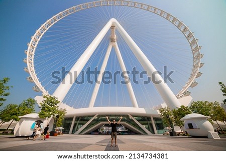 The man tourist threw up her hands in delight at the sight Ain (Eye) DUBAI - One of the largest Ferris Wheels in the World, located on Bluewaters island. 