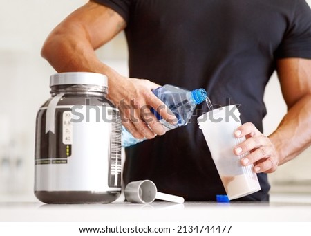 Getting enough protein in your diet. Cropped image of a bodybuilder making himself a protein shake. Royalty-Free Stock Photo #2134744477