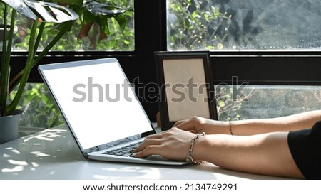 Male freelancer working online with laptop computer at home office.