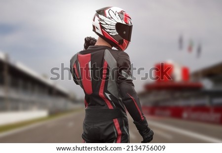 Motorcyclist in full gear and helmet on the race track. Royalty-Free Stock Photo #2134756009