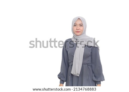 Beautiful asian muslim woman standing against white background