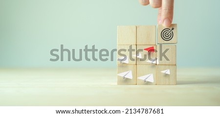 Business goals and strategies concept. Market leader. Wooden cutes with target and strategies icon on grey background. Business opportunities, planning, common goals, planning and strategies.  Royalty-Free Stock Photo #2134787681