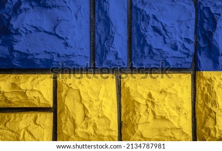 Flag of Ukraine on stone bricks wall in background 